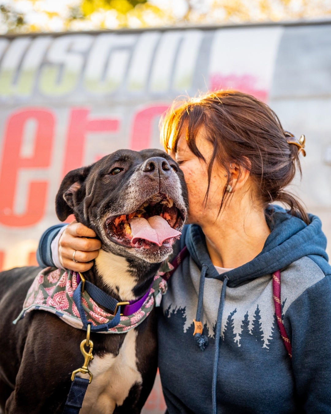 woman kissing dog