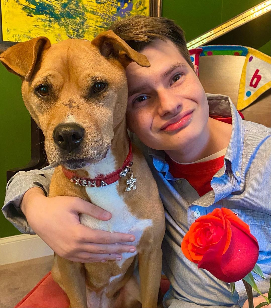 a boy posing with his dog