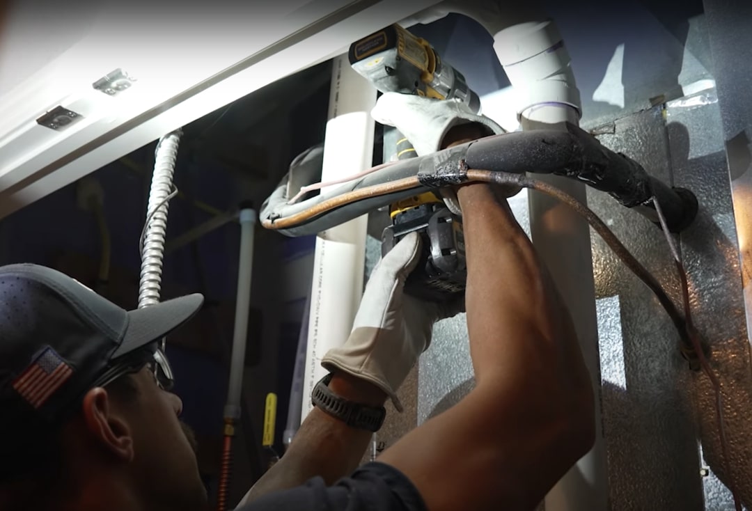 a man trying to open ductwork