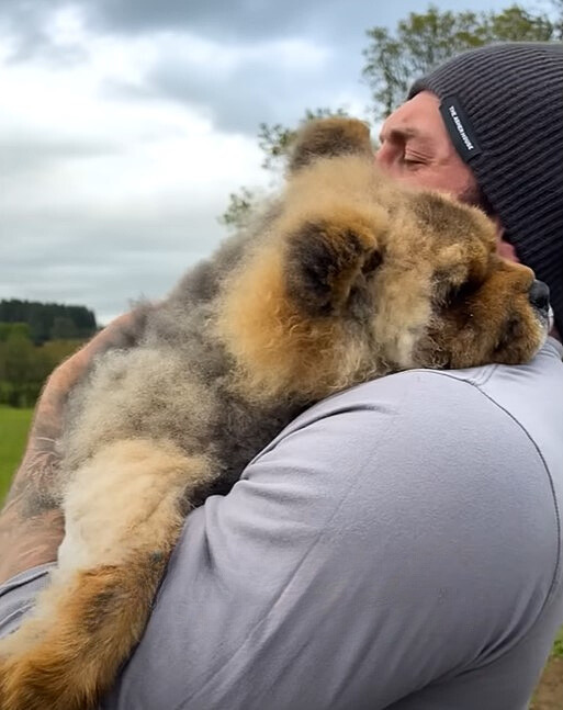 guy holding a cute dog