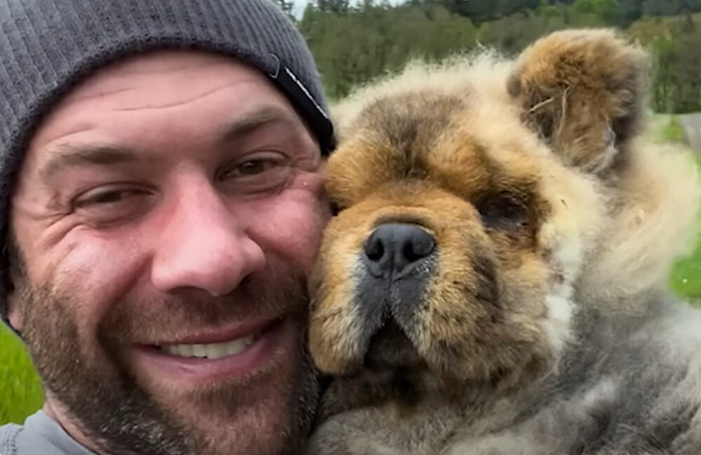 happy guy holding a dog