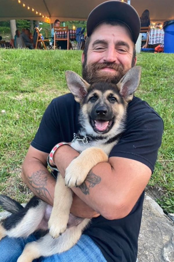 happy man holding the pup