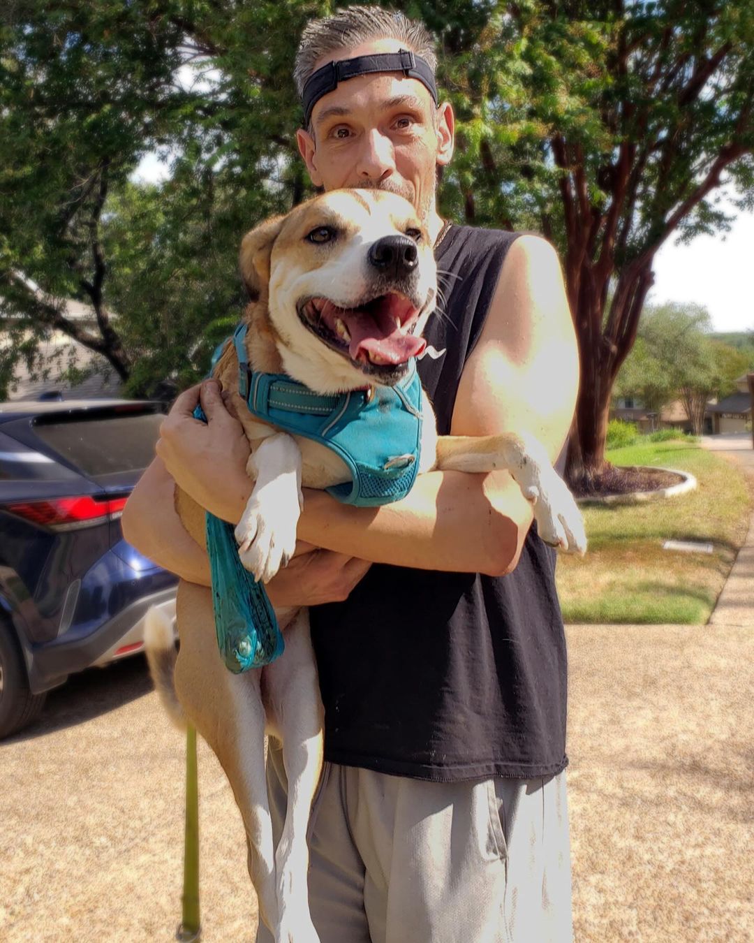 man carrying a dog