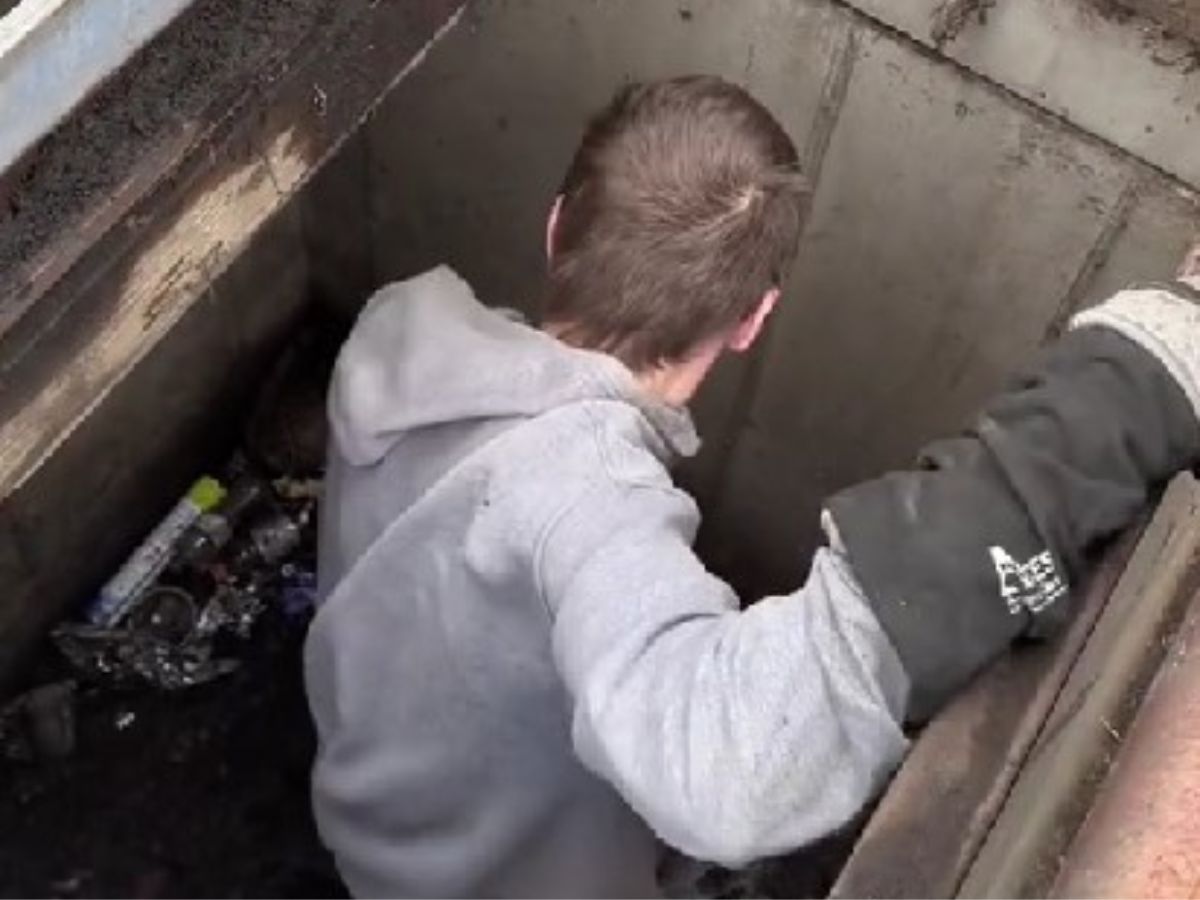 man in drain hole