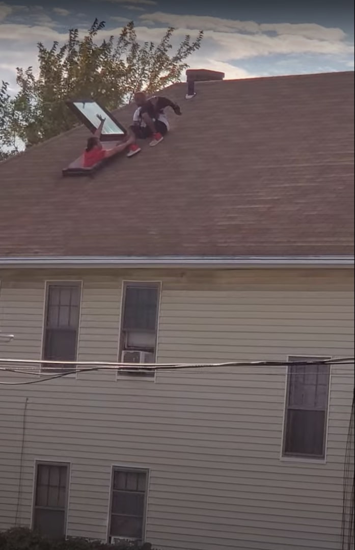 man on the roof with dog