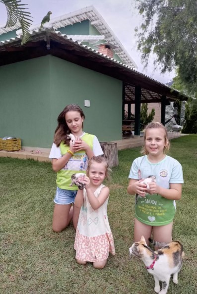 three girls holding kittens