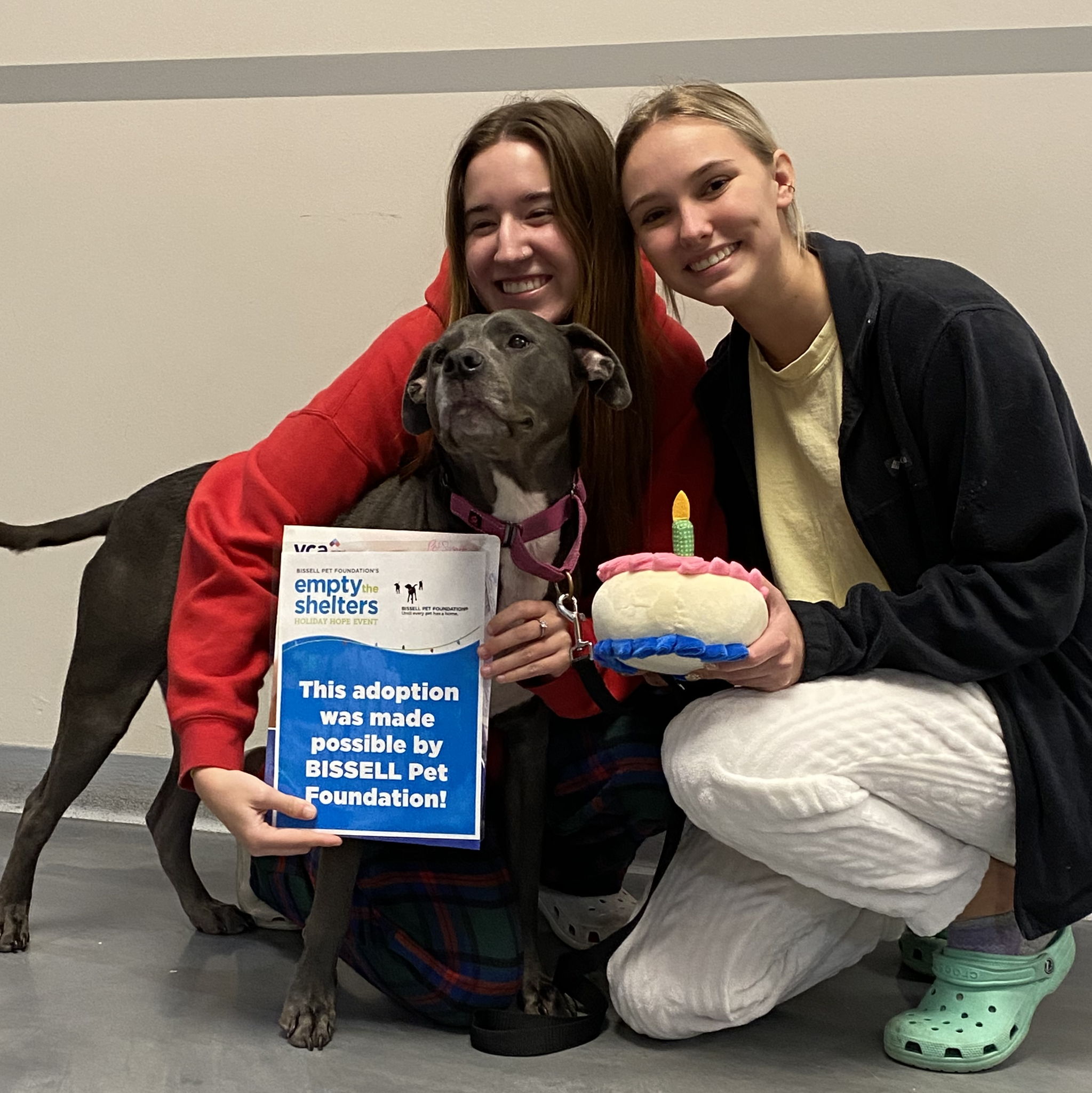 Two girls with a black dog