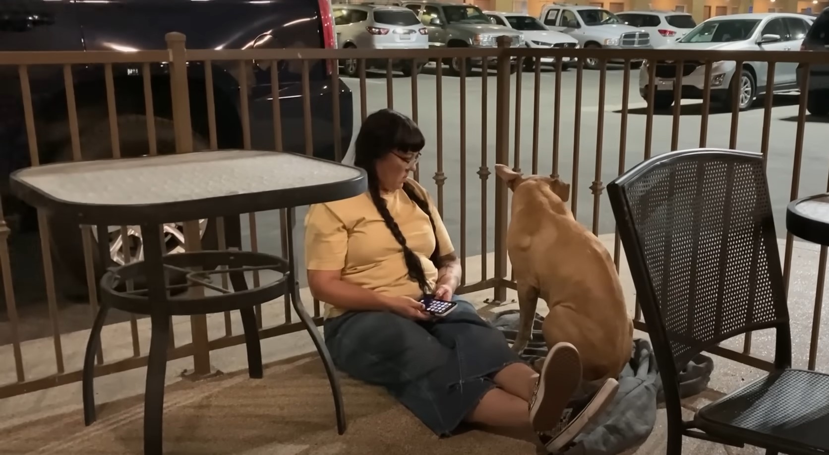 woman and dog sitting on the ground