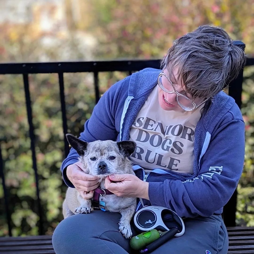 woman holding a dog in her lap