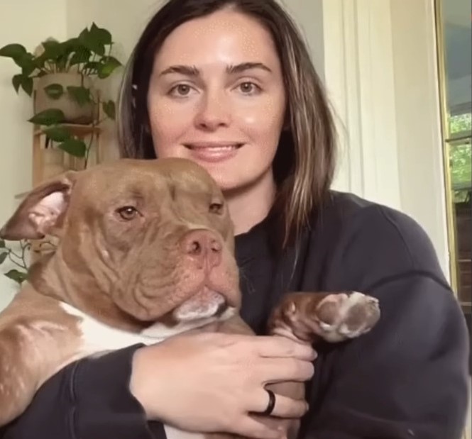 woman holding a dog