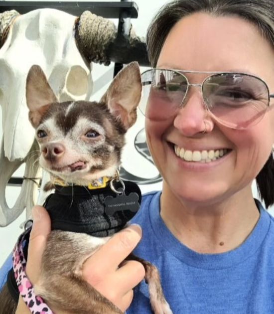 woman holding a happy puppy