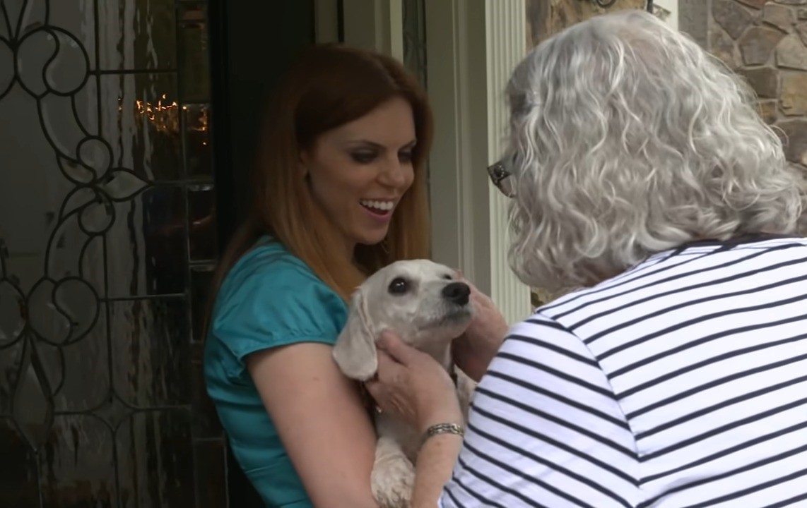 woman holding a puppy