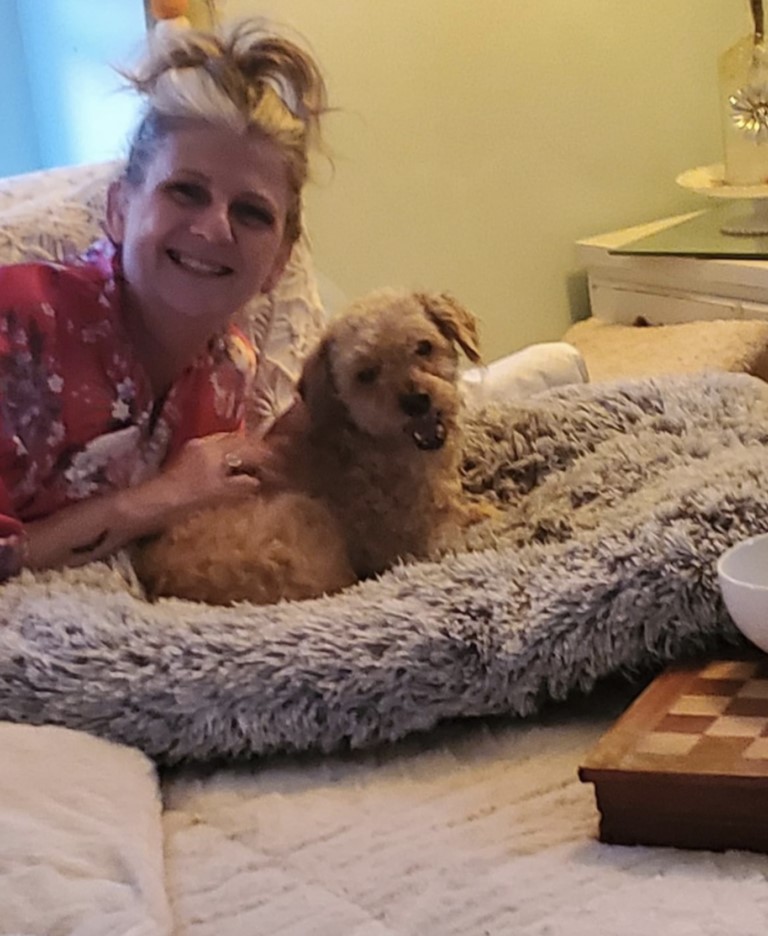 woman lying next to a dog