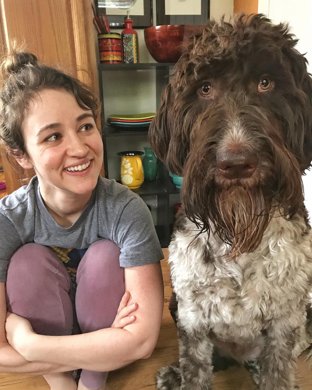 woman sitting next to dog