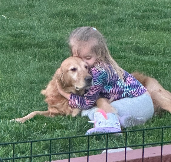 little girl hugging the dog