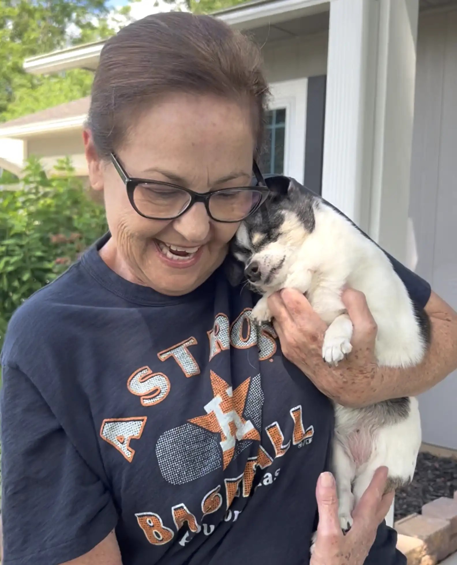 woman holding a blind dog