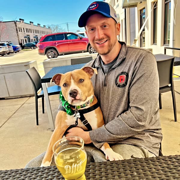 dog sitting in man's lap