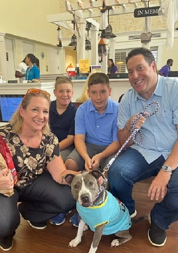 family posing with dog