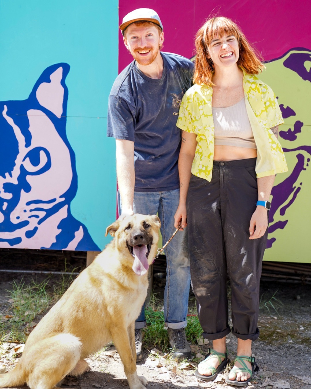 happy couple posing with their new dog