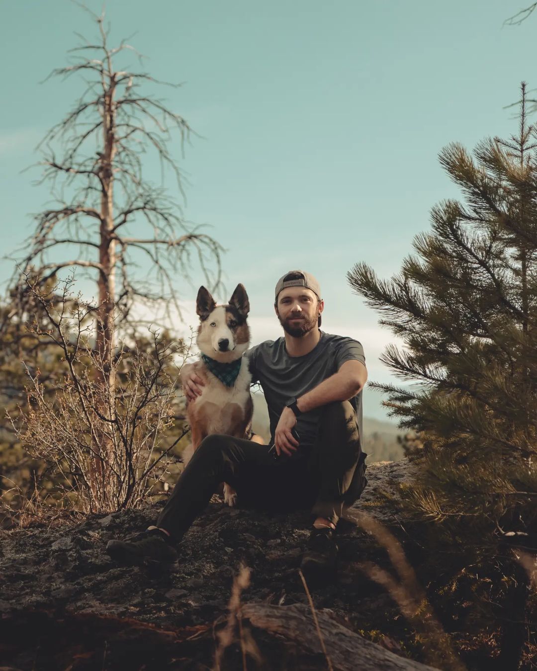 man and a dog in the woods