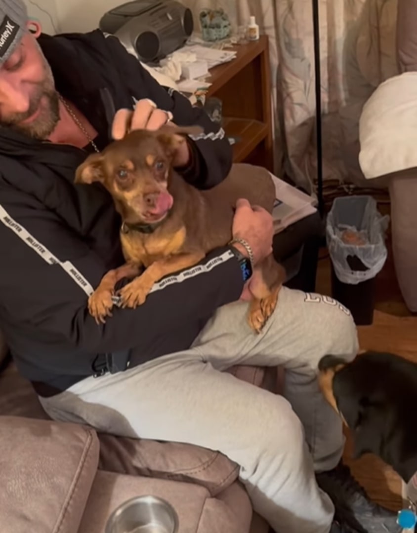 man holding a cute dog