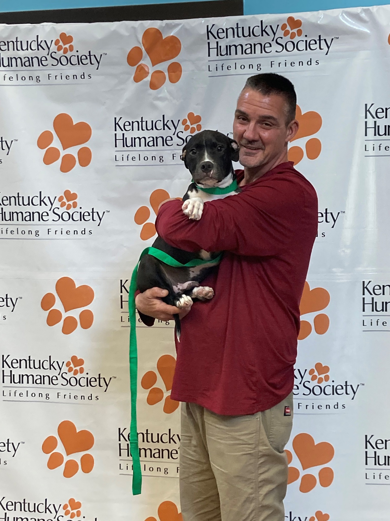 new owner holding the dog in his arms