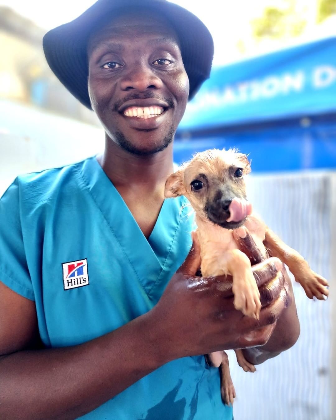 smiling man holds a puppy