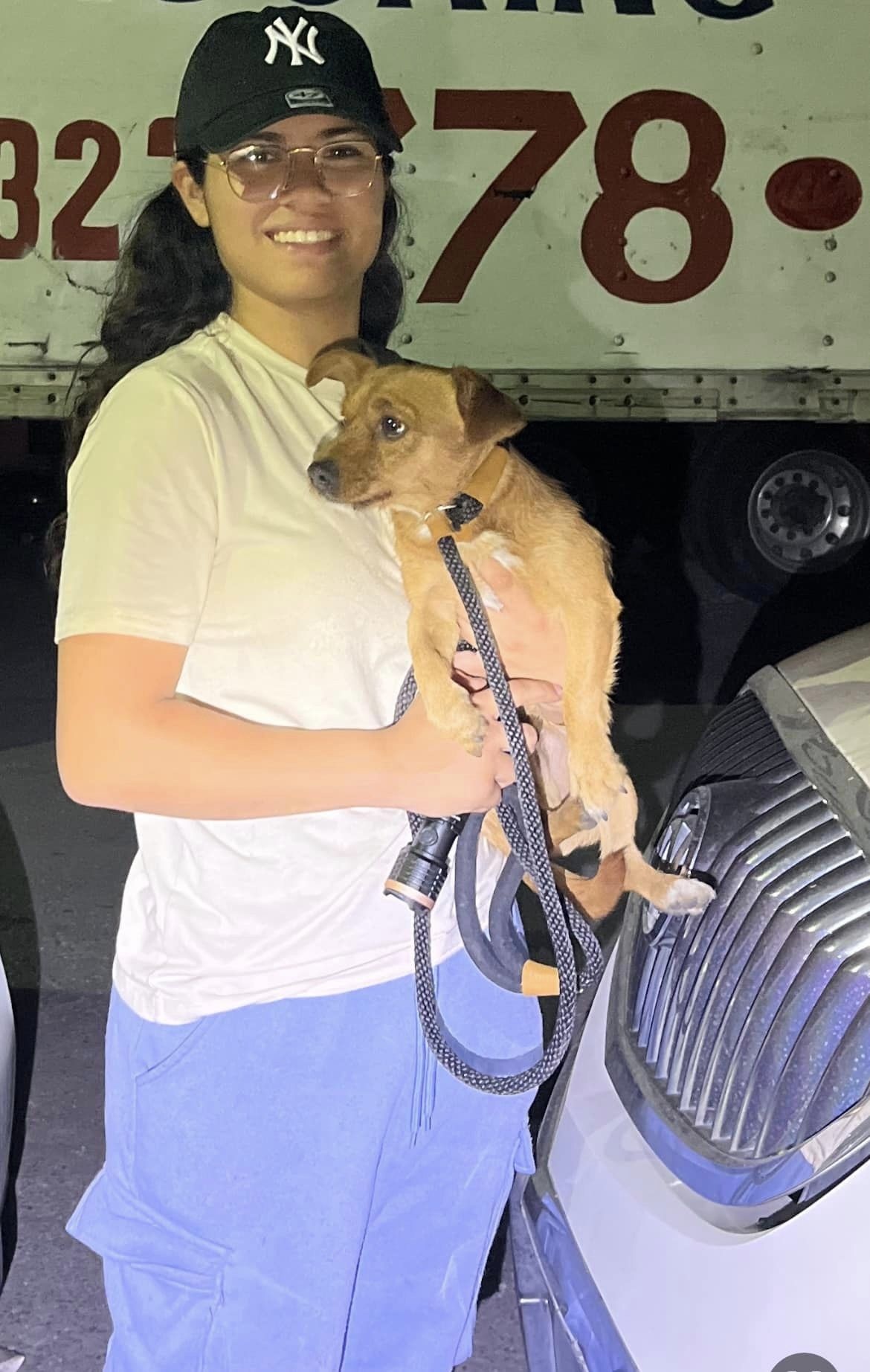 smiling woman holding puppy