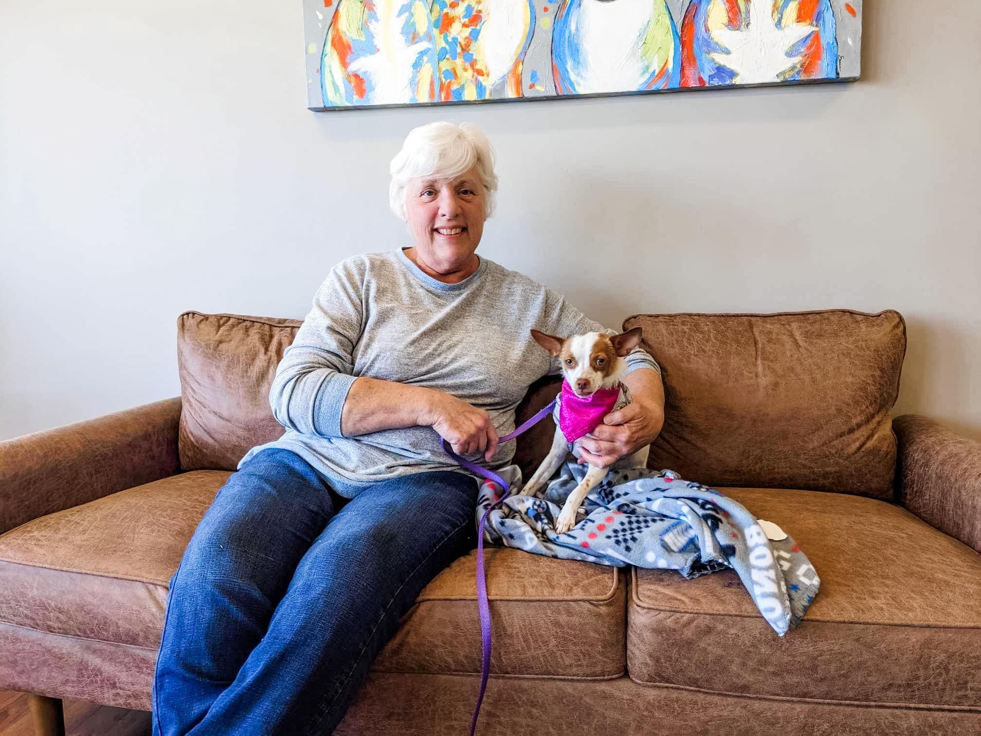 woman and dog sitting on a couch