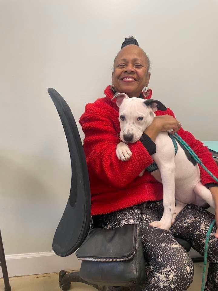 black woman holding a dog