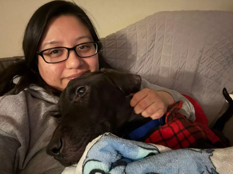 dog laying on a woman