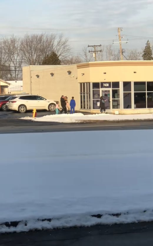 man walking and holding a dog