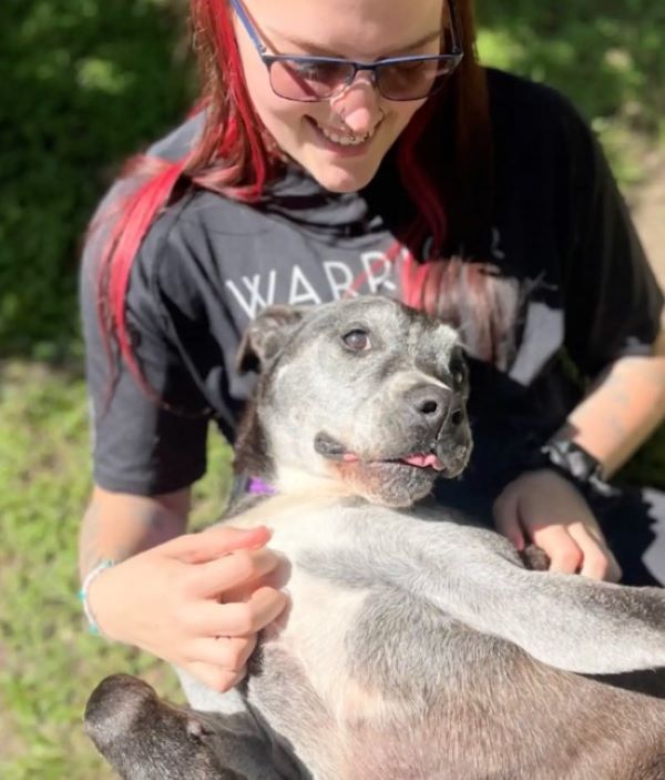 woman and black dog