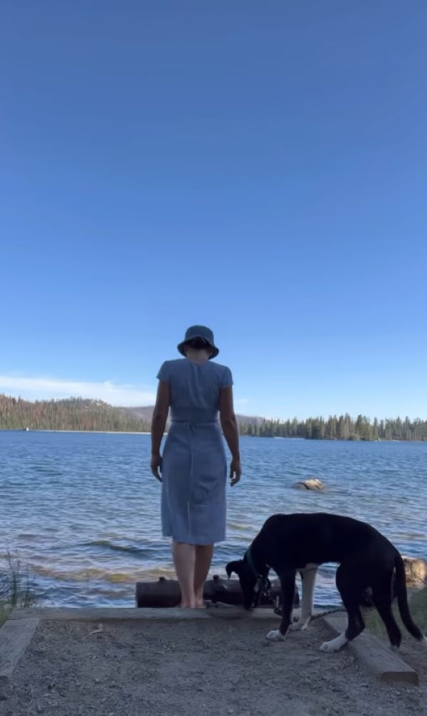 woman and dog near lake