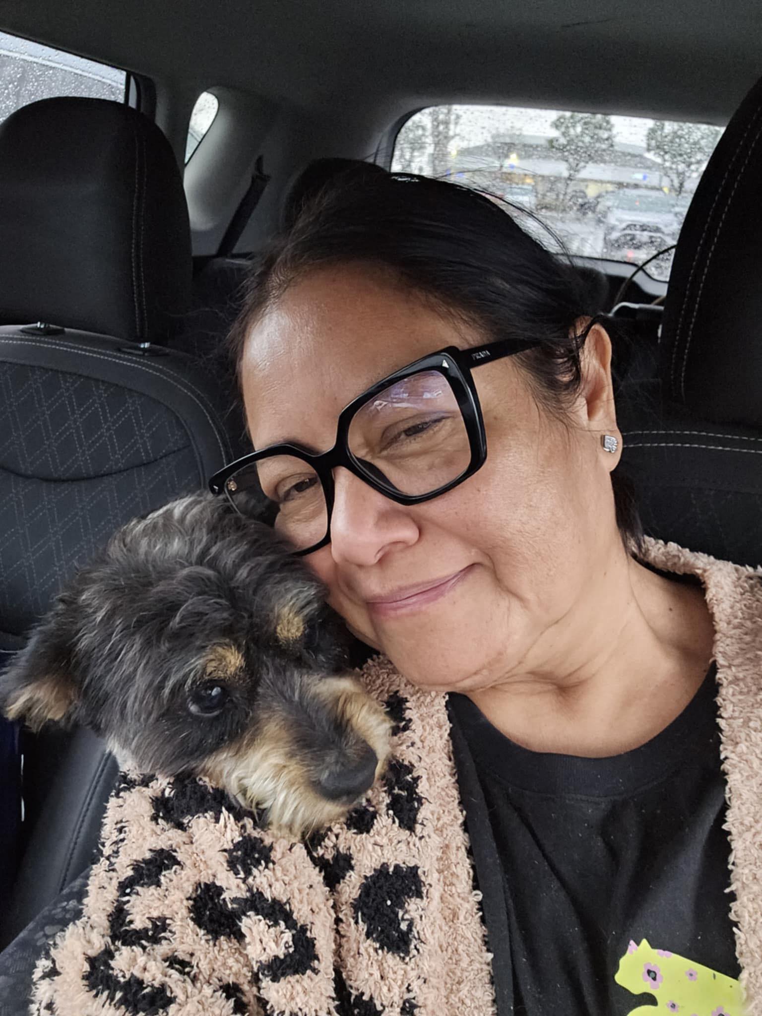 woman and her dog in a car