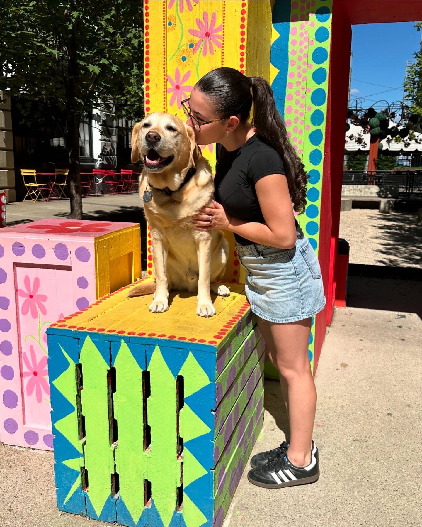 woman kissing a senior dog